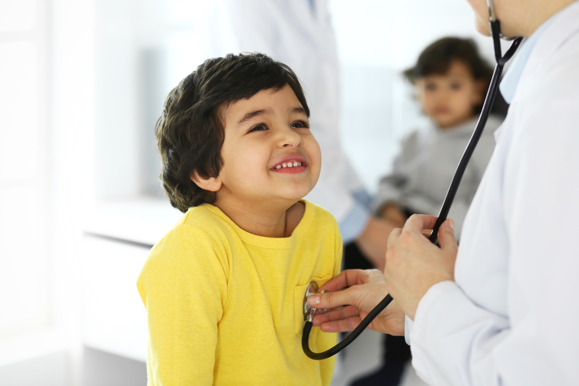 Image of Doctor examining patient for student health in a school based health center